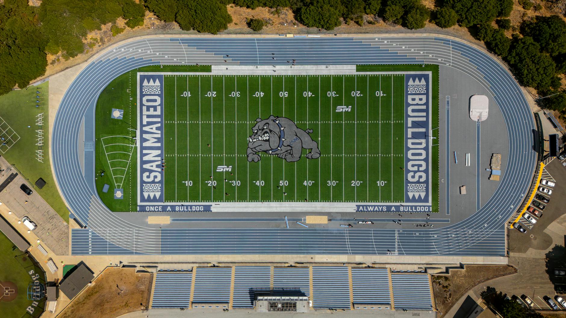 Aerial shot of San Mateo high school football field and track with bulldog logo and track lanes.